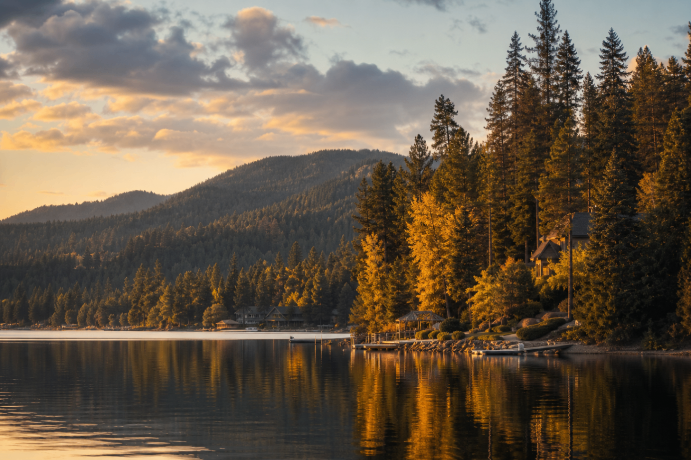 Golden evening light across Hayden Lake with forested shoreline and mountain views