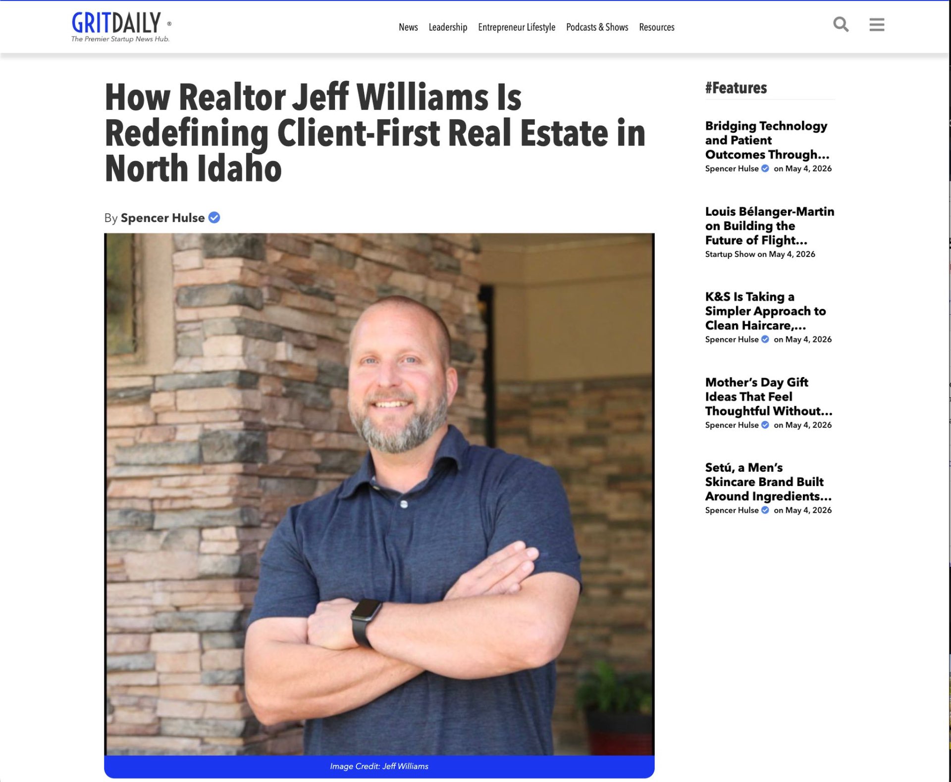 Jeff Williams featured in Grit Daily News, standing in front of a stone wall, arms crossed
